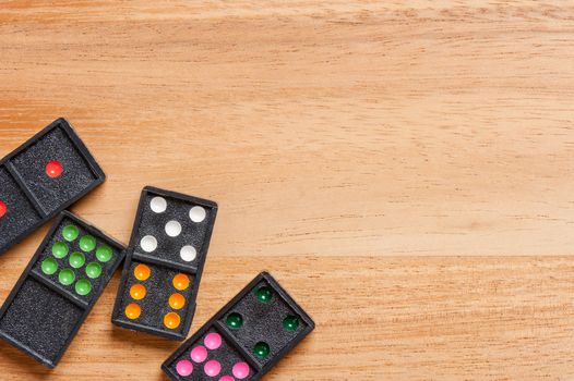 Dominoes on wooden table. Dominoes is a game played with rectangular "domino" tiles.