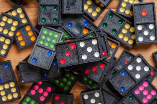 Dominoes on wooden table. Dominoes is a game played with rectangular "domino" tiles.