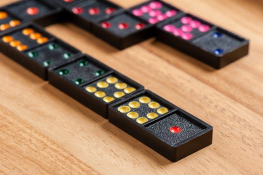 Dominoes on wooden table. Dominoes is a game played with rectangular "domino" tiles.