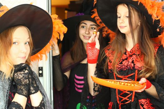 Lovely girls are trick or treating. Halloween fun.