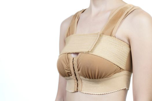 Woman posing in support bra after breast augmentation plastic surgery with silicone breast implants.