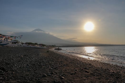 Sunset over the Bali Sea, near to Agung volcano, Bali in Indonesia. Sunset landscape. Tropical sunset.