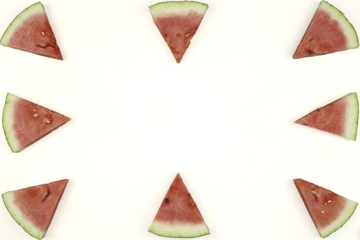 Triangular isolated slices of watermelon forming geometric games for copy space on a white background