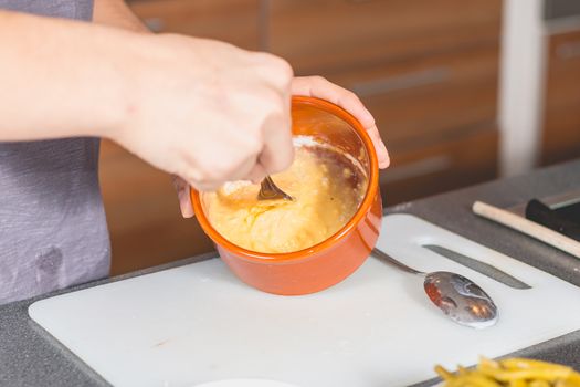 Cooking mixture of flour and eggs in a container