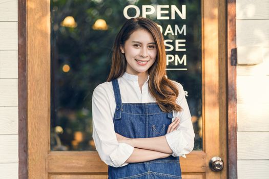 Portrait Asian Small business owner doing Hands crossed for Welcome Open in front of coffee shop, startup with cafe store, installing open and close label concept