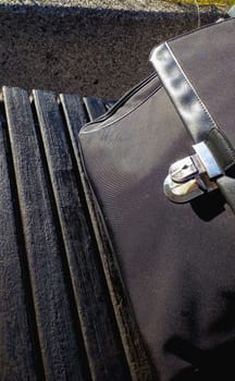 wooden bench with a black businessman briefcase