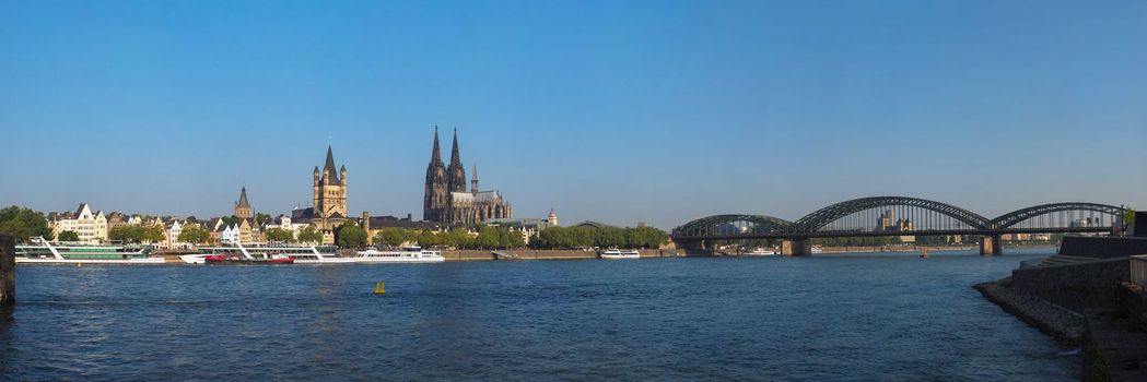 Skyline of the city of Koeln, Germany seen from River Rhein (Rhine). From left to right, the Altstadt (old town), Rathaus (town hall), Dom (cathedral) and Hohenzollern Bridge
