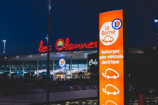 Olonne sur Mer, France - December 03, 2016 : During the Christmas period, at the entrance of the car park of a shop of the "Leclerc" chain in Olonnes sur Mer, France, a panel invites the owners of electric car to recharge their vehicle.