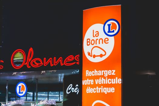 Olonne sur Mer, France - December 03, 2016 : During the Christmas period, at the entrance of the car park of a shop of the "Leclerc" chain in Olonnes sur Mer, France, a panel invites the owners of electric car to recharge their vehicle.