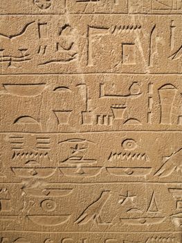 Ancient Egypt tomb hieroglyphs stone wall background