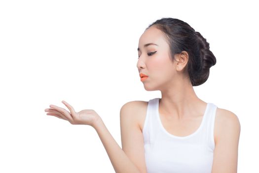 Beauty spa woman with perfect face skin Portrait. Beautiful Spa Girl showing empty copy space on the open hand palm for text. Proposing a product. Gesture for advertisement. Isolated on white background