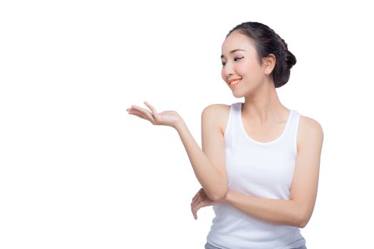 Beauty spa woman with perfect face skin Portrait. Beautiful Spa Girl showing empty copy space on the open hand palm for text. Proposing a product. Gesture for advertisement. Isolated on white background