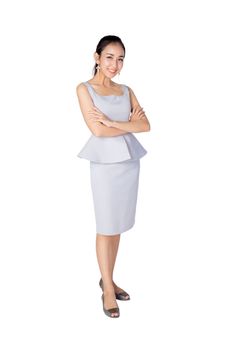 Smiling business woman standing against white background with crossed arms.