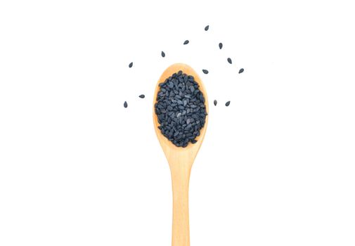 Black sesame seeds in wooden scoop on white background