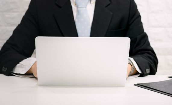 Business men work using computers on their desks