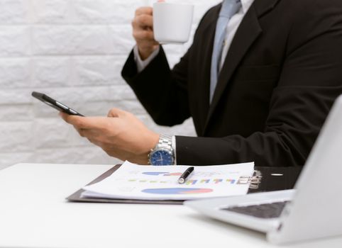 Coffee break businessman executive working relax on laptop at his desk.