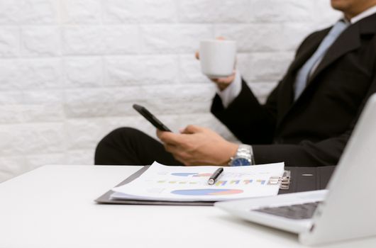 Coffee break businessman executive working relax on laptop at his desk.