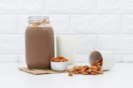 Milk Chocolate and Almonds in a glass on a white background
