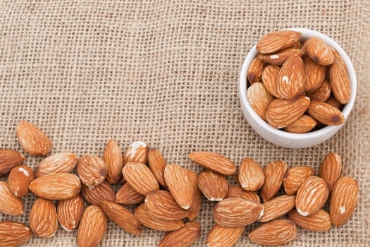 Almonds In a cup on fabric sacks