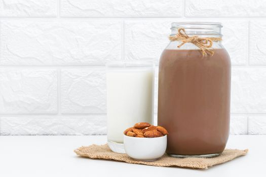 Milk Chocolate and Almonds in a glass on a white background