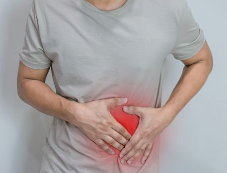 Man suffering from stomach ache with both palm around waistline to show pain and injury on belly area