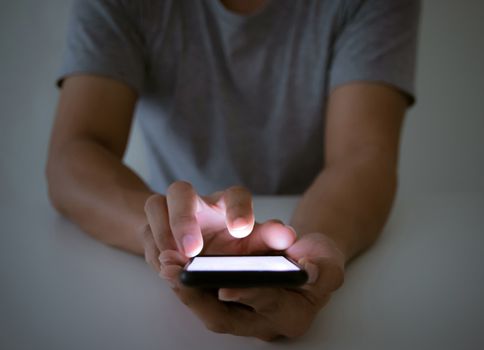 A man with a smartphone social and a touch screen monitor