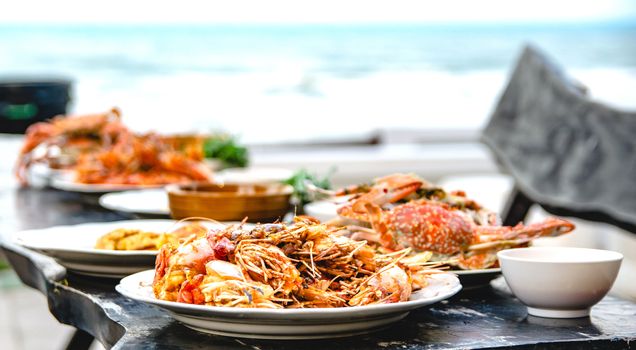 Shrimp fried garlic seafood of restaurant with other dishes in the background