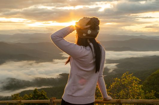 Woman relax touring in the mountain fog the morning sun