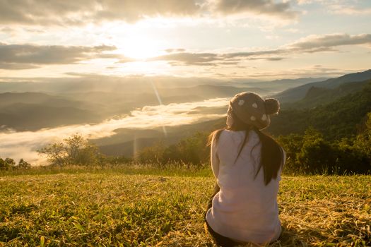 Woman relax touring in the mountain fog the morning sun