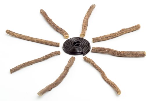 Liqorice roots and black wheel on white background