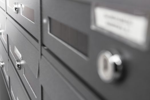 Rows of aluminum mail boxes for concepts such as safety and security, business communication and concepts. Shallow depth of field.