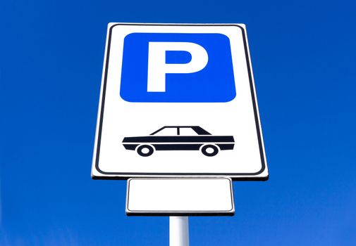 Car parking sign against clear sky background. Blank label and sky for text.