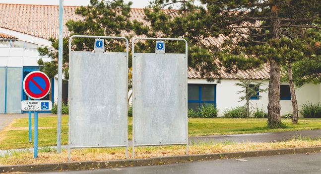 Bretignolles sur Mer, France - April 25, 2016 : During the presidential election in France in front of a polling station, one installs campaign billboard or will be posted posters of the candidates