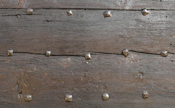 Wooden background with old nails