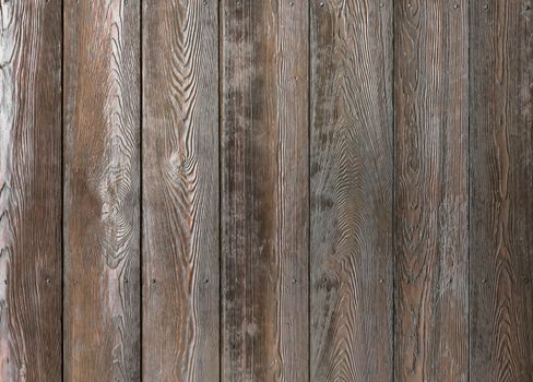 Textural image: surface of dark roughly polished wooden boards.