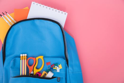 Top view flat lay of blue school bag backpack and accessories tools for children education on pink background, Back to school concept and have copy space for use