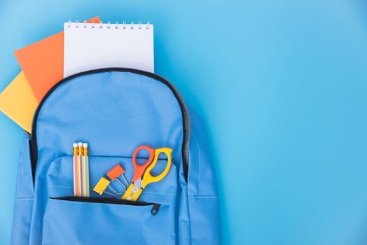 Top view flat lay of blue school bag backpack and accessories tools for children education on blue background, Back to school concept and have copy space for use