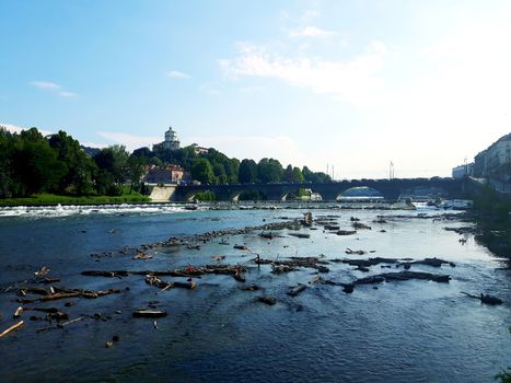 Turin, Italy - 06/06/2020: Beautiful panoramic view from Mole Antoneliana to the city of Turin in summer days with clear blue sky and the alps in the background.