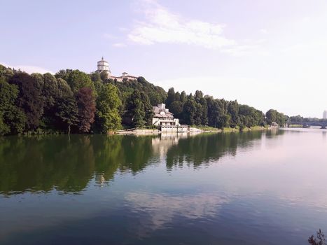 Turin, Italy - 06/06/2020: Beautiful panoramic view from Mole Antoneliana to the city of Turin in summer days with clear blue sky and the alps in the background.