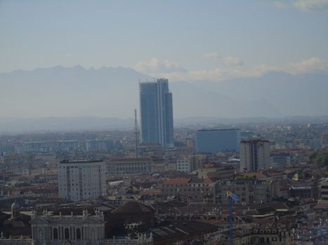 Turin, Italy - 06/06/2020: Beautiful panoramic view from Mole Antoneliana to the city of Turin in summer days with clear blue sky and the alps in the background.