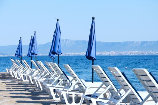 Rows of empty chaise-lounges over sea background, Supetar, Brac island, Croatia