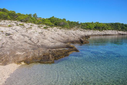 Turquoise sea water white stone beach and mountains, Sumartin, Brac island, Croatia