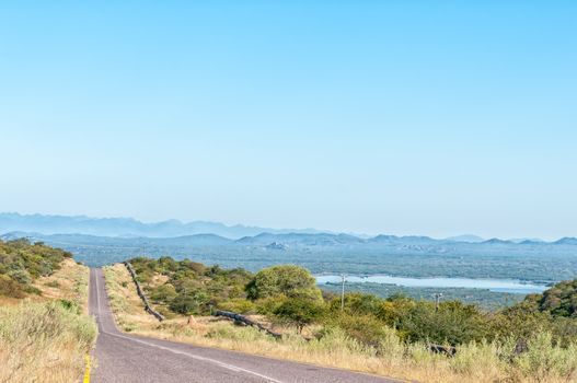 Road C46 to the Ruacana waterfall in the Kunene River. The Calueque Dam in Angola is visible in the back