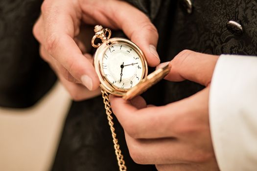 pocket watch in hands holding old clock. High quality photo