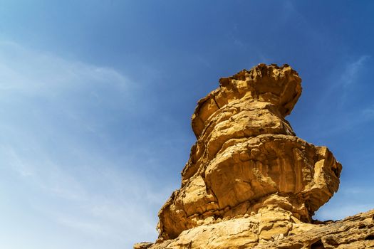 Impressive solitary rock with Eolian erosion marks in the desert of Wadi Rum, Jordan, middle east