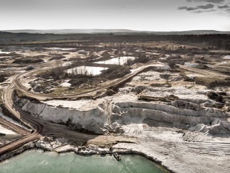 Aerial view of the edge of a large white sand quartz quarry, made with drone