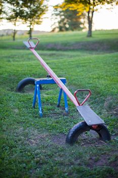 Old empty metal seesaw in an outdoor children's playground