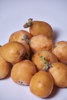 Set of medlars in order on white table, natural, ecological, without retouching