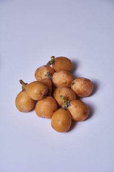 Set of medlars in order on white table, natural, ecological, without retouching