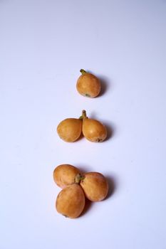 Set of medlars in order on white table, natural, ecological, without retouching